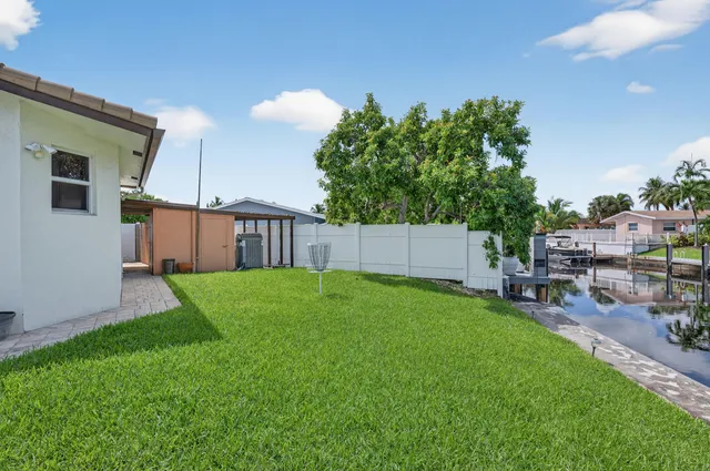 a view of a swimming pool with a patio and a garden
