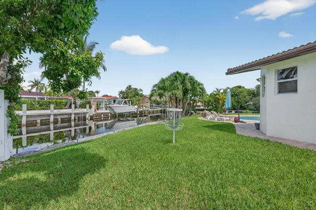 an aerial view of a house with a garden and lake view