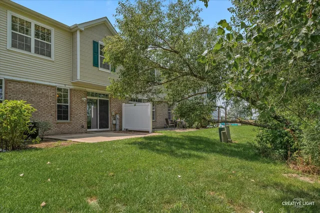 a backyard of a house with table and chairs