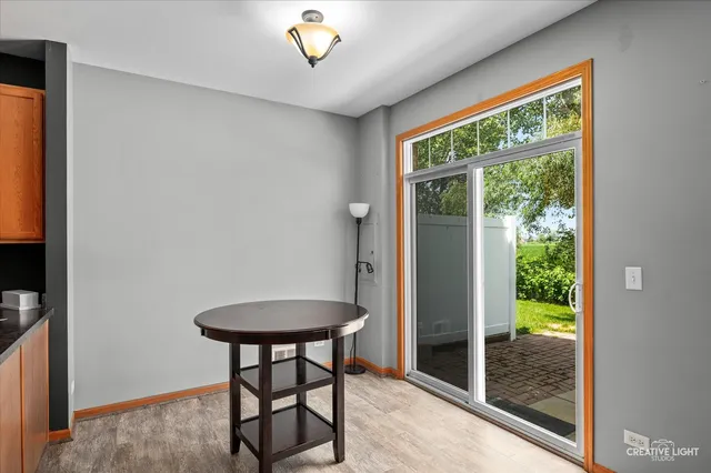 a view of a livingroom with a table and chair