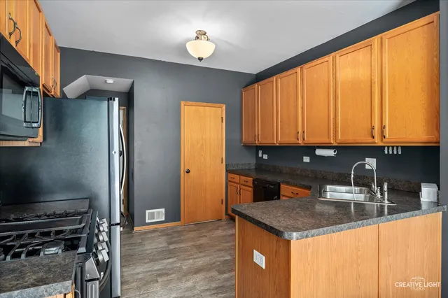 a kitchen with a sink a counter top space and cabinets