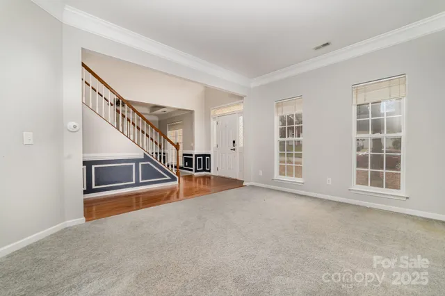 a view of an empty room with stairs