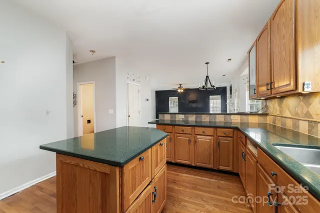 a kitchen with stainless steel appliances granite countertop a sink and cabinets