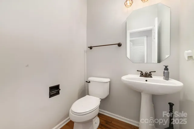 a bathroom with a sink mirror and toilet
