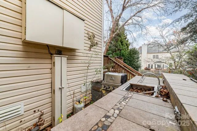 a view of a patio with table and chairs with wooden floor and fence