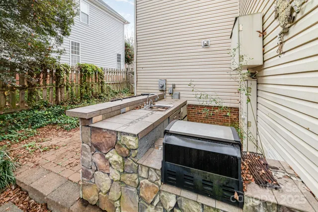 a view of a pathway of a house with wooden fence