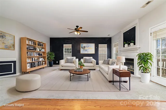 a living room with fireplace furniture and a flat screen tv