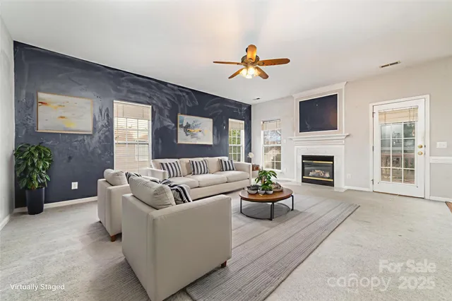 a living room with furniture fireplace and a flat screen tv