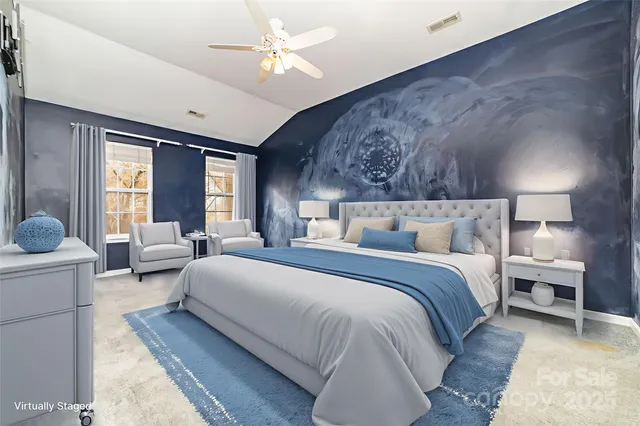 a spacious bedroom with bed and a chandelier