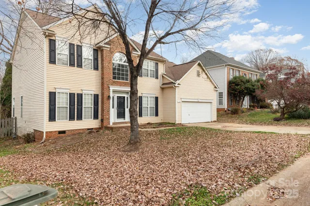 a backyard of a house with large trees and barbeque oven