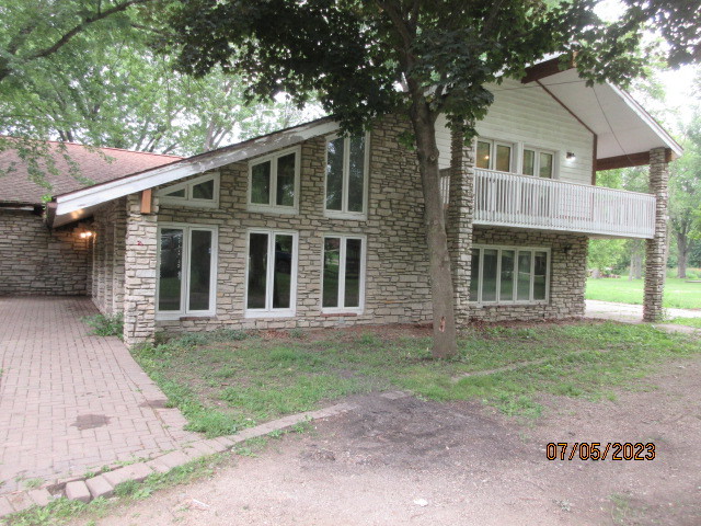 2115 Highwood Road McHenry, IL 60051 - Photo 1 of 31 a front view of a house with a garden