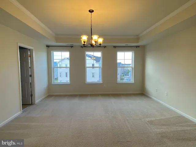 a view of a room with chandelier and windows