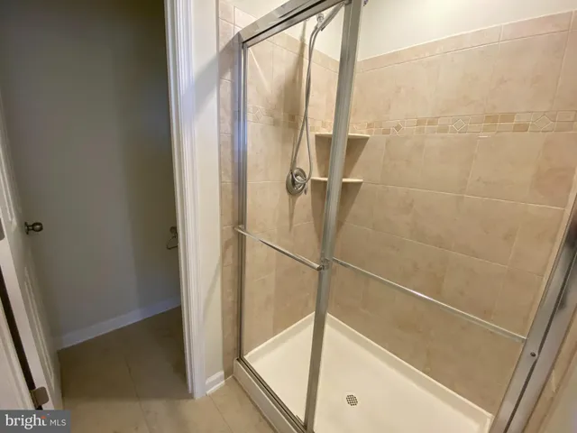 a bathroom with a glass shower door