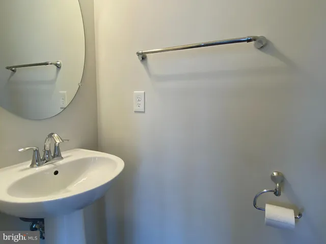 a bathroom with a sink and mirror
