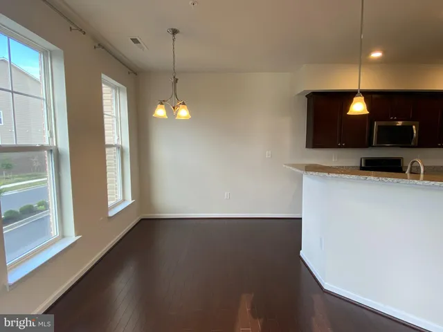 a view of a kitchen with a sink and a window