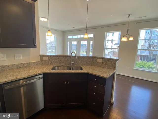 a view of a kitchen counter space and wooden floor