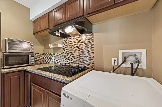 a kitchen view of a stove and a microwave