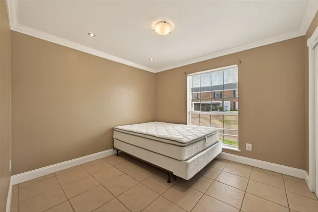 a bed sitting in a room next to a window