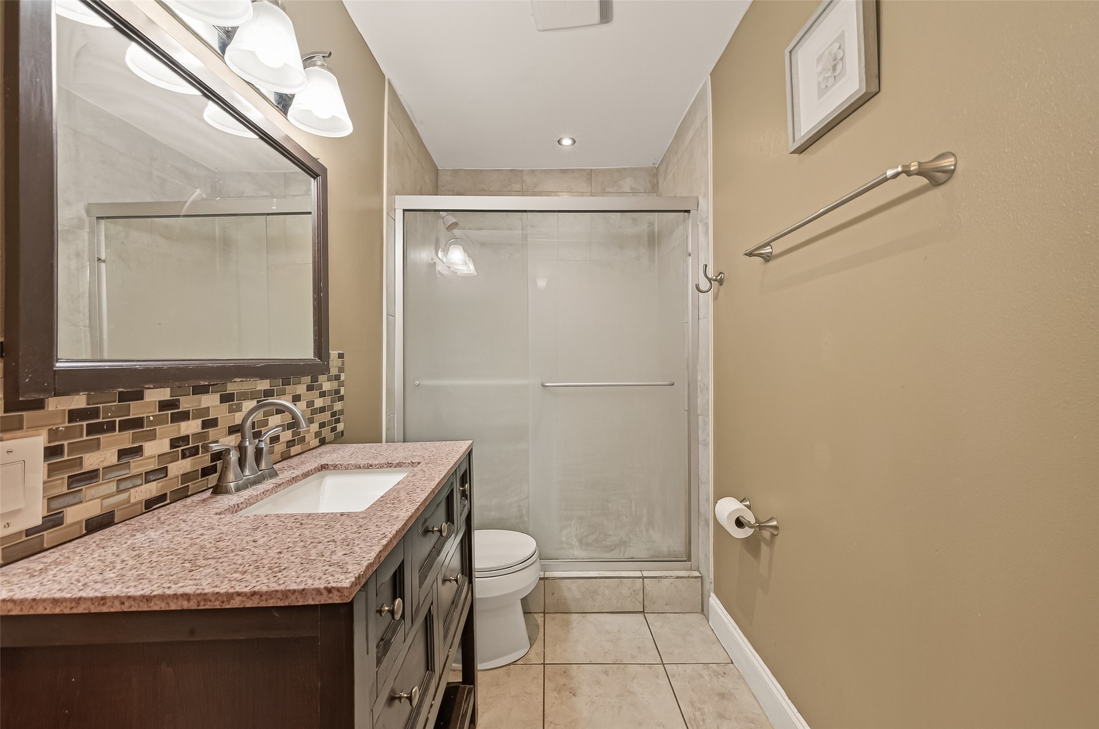 2201 Fountain View Drive, Unit 3 Houston, TX 77057 - Photo 16 of 20 a bathroom with a granite countertop sink a mirror and a shower