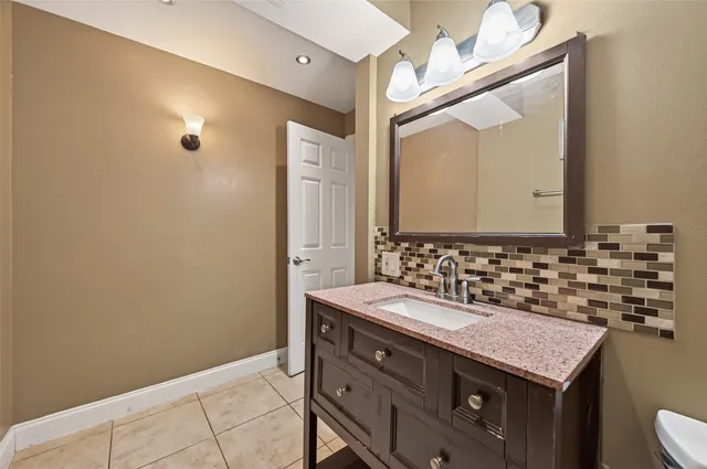 a bathroom with a sink vanity and a mirror