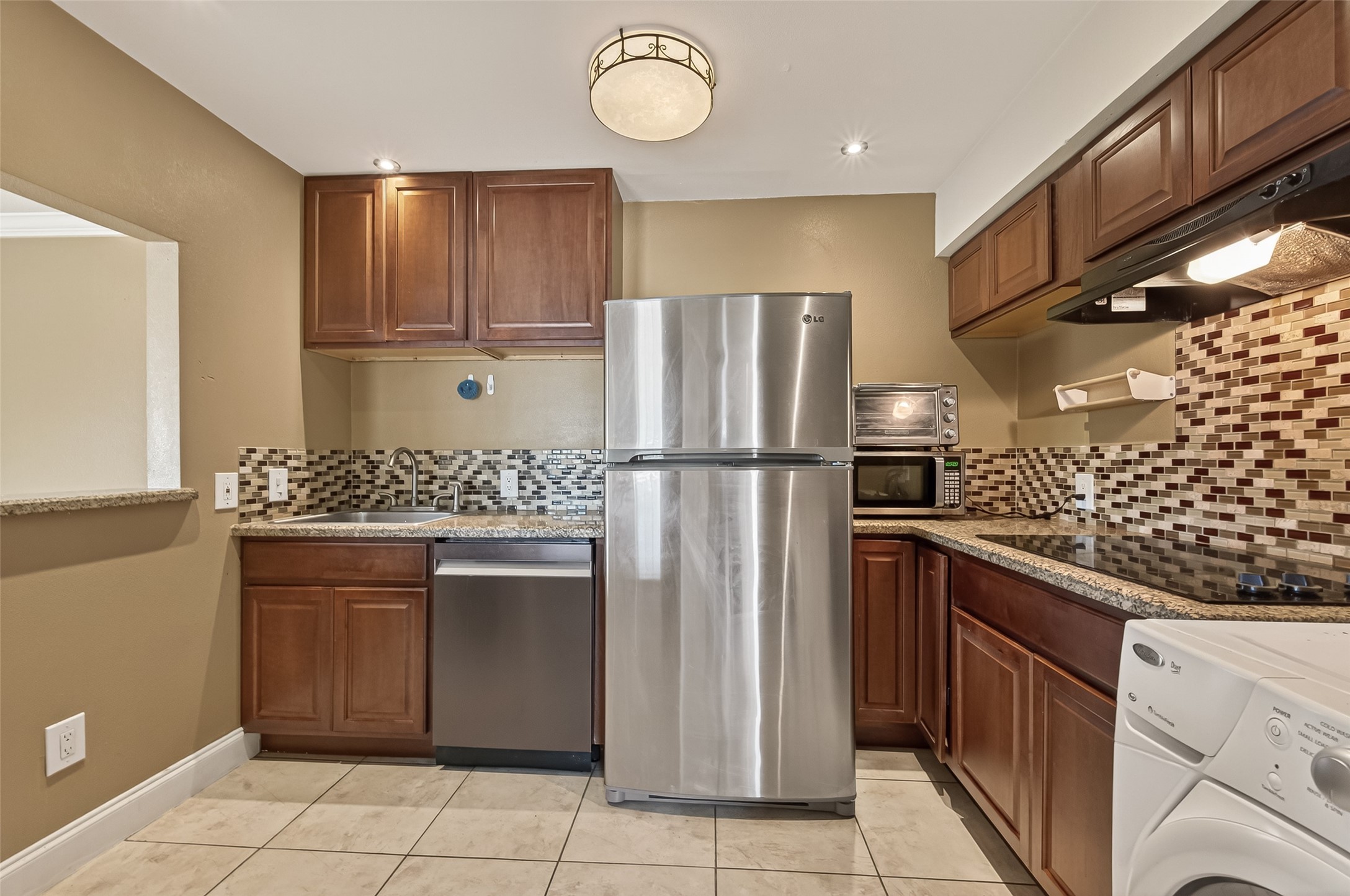 2201 Fountain View Drive, Unit 3 Houston, TX 77057 - Photo 8 of 20 a kitchen with stainless steel appliances granite countertop a refrigerator and a stove