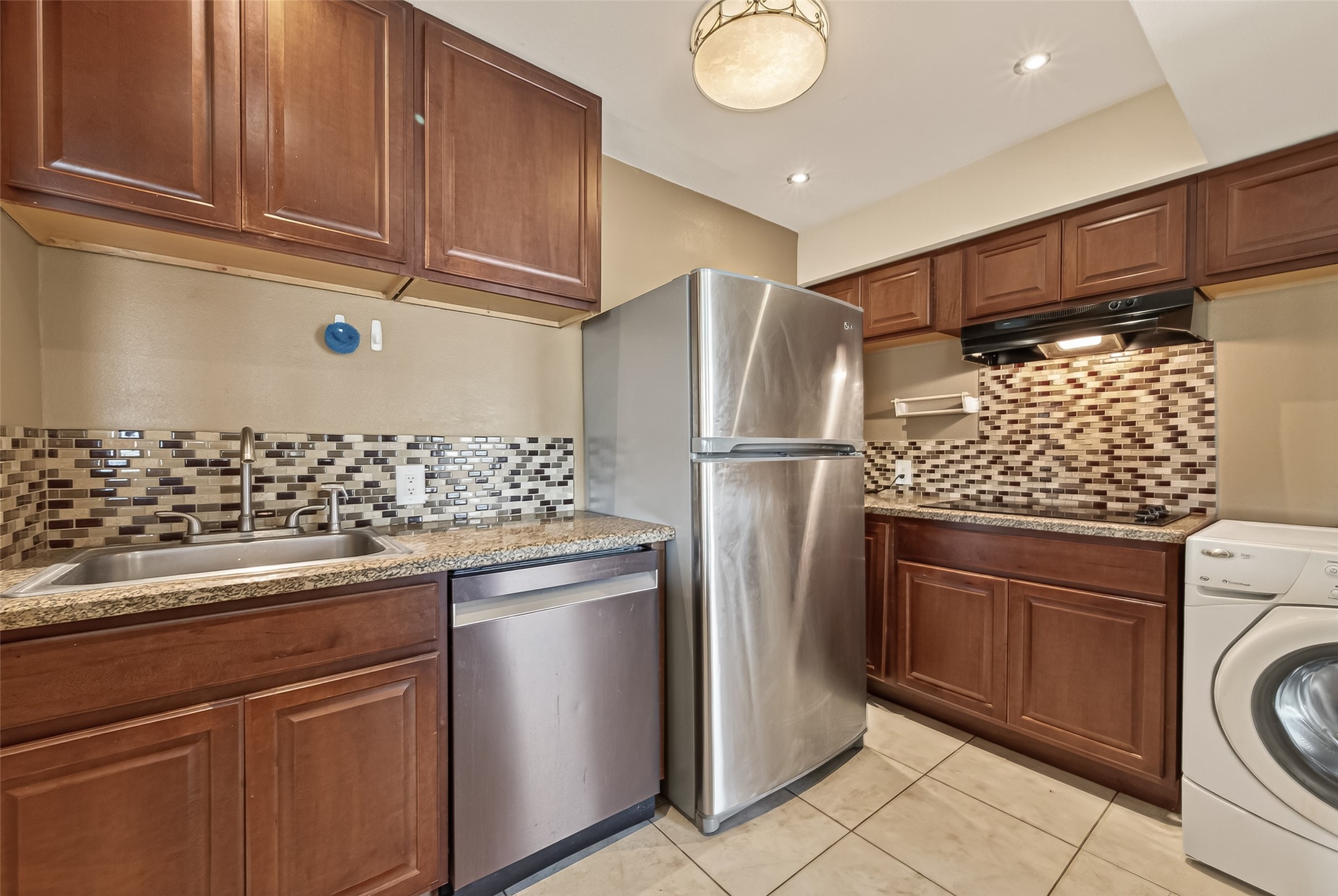 2201 Fountain View Drive, Unit 3 Houston, TX 77057 - Photo 9 of 20 a kitchen with a refrigerator and cabinets
