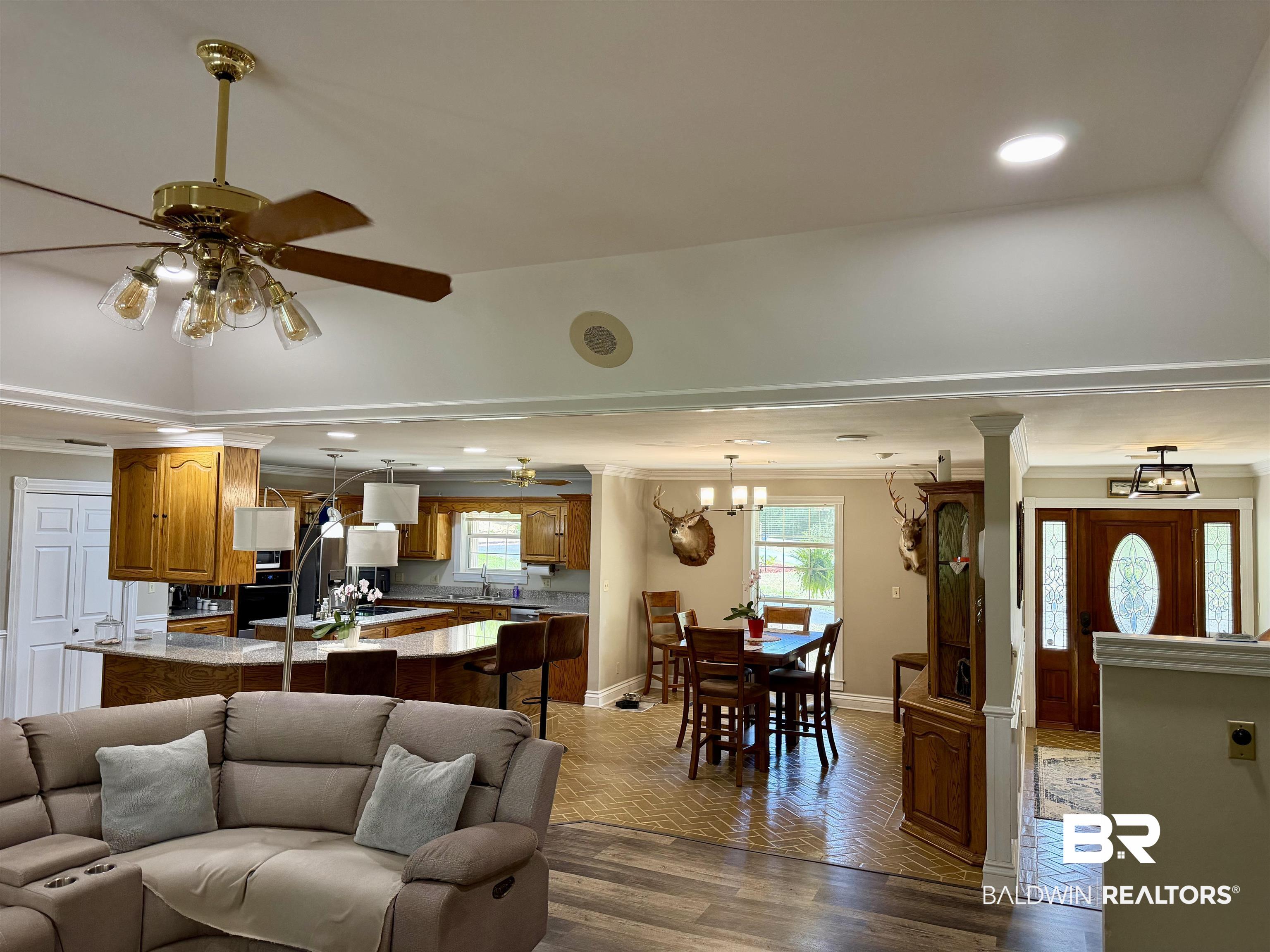 2944 Appleton Road Brewton, AL 36426 - Photo 11 of 65 Living room with parquet floors, ceiling fan, ornamental molding, and hanging lights