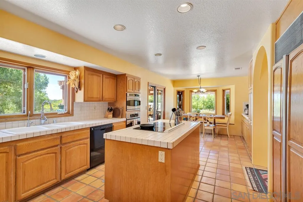 23250 Old Ranch Road Alpine, CA 91901 - Photo 5 of 25 a large white kitchen with a large window