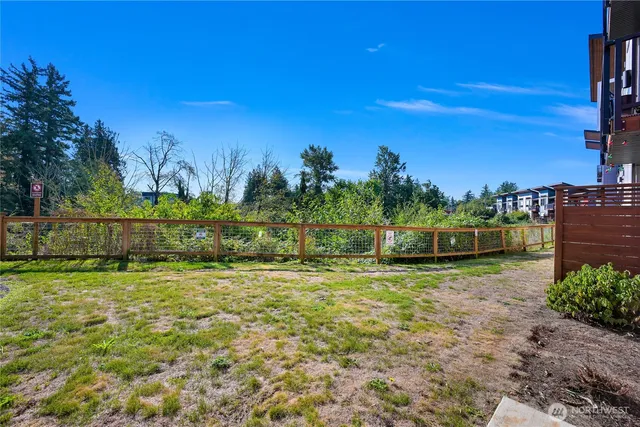 a view of a yard with a house in the background