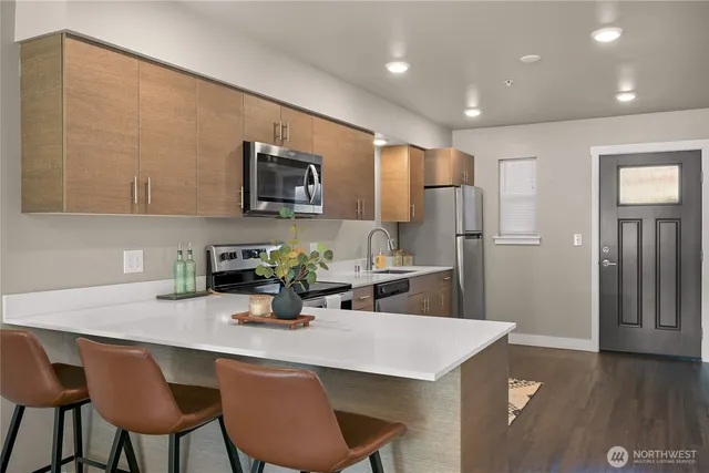 a kitchen with refrigerator and cabinets