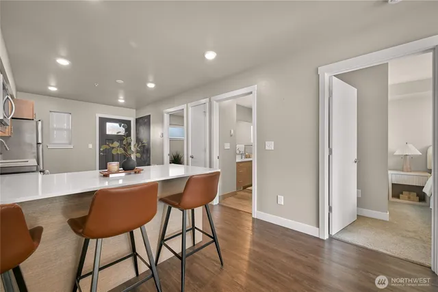 a view of a dining room with furniture and wooden floor