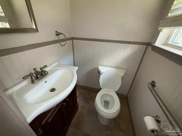 a bathroom with a sink mirror vanity and toilet