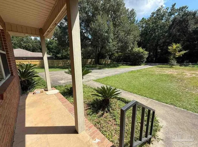 a view of a backyard with sitting area
