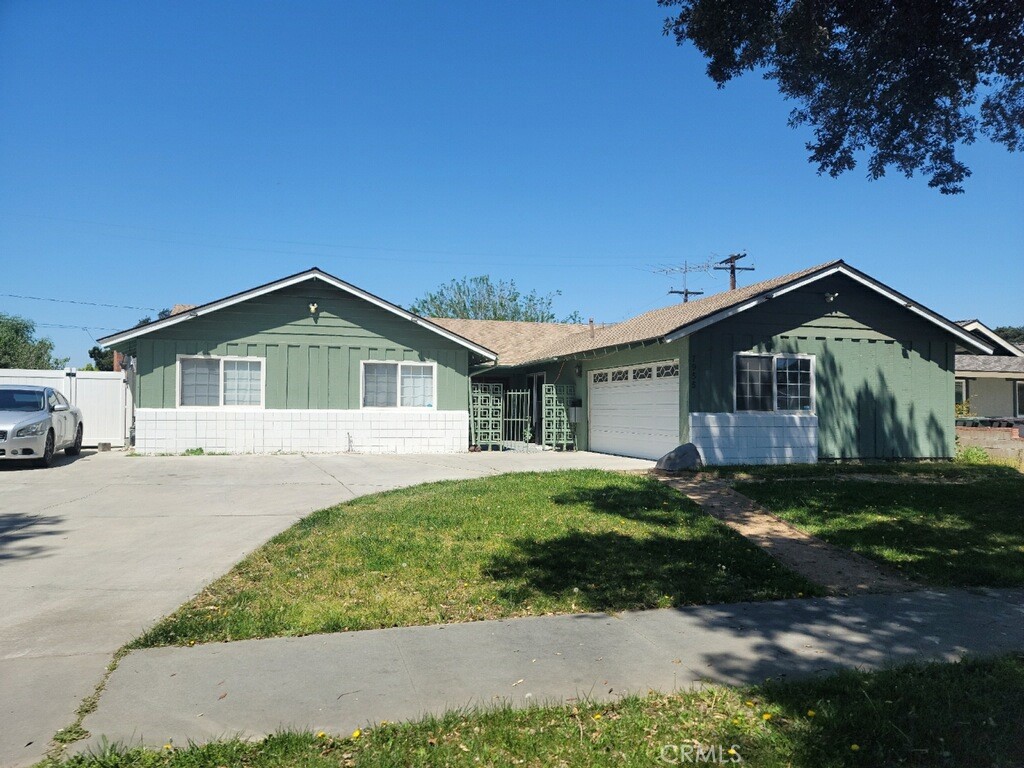 7955 Stella Street Riverside, CA 92504 - Photo 1 of 1 a front view of a house with a yard