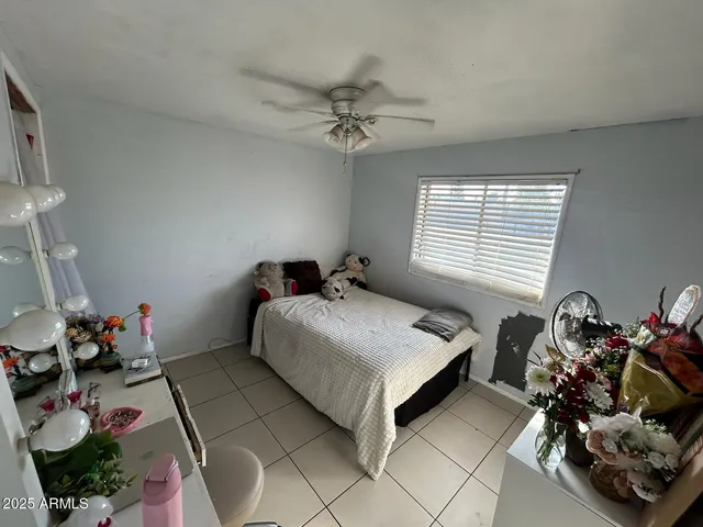 a bedroom with a bed and a dresser