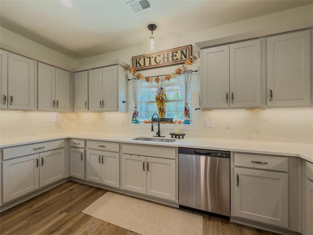 710 Poplar Street Monroe, GA 30655 - Photo 12 of 60 a kitchen with white cabinets and sink