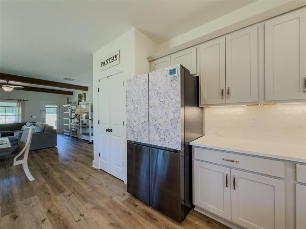 710 Poplar Street Monroe, GA 30655 - Photo 16 of 60 a kitchen with stainless steel appliances granite countertop a refrigerator and a cabinets