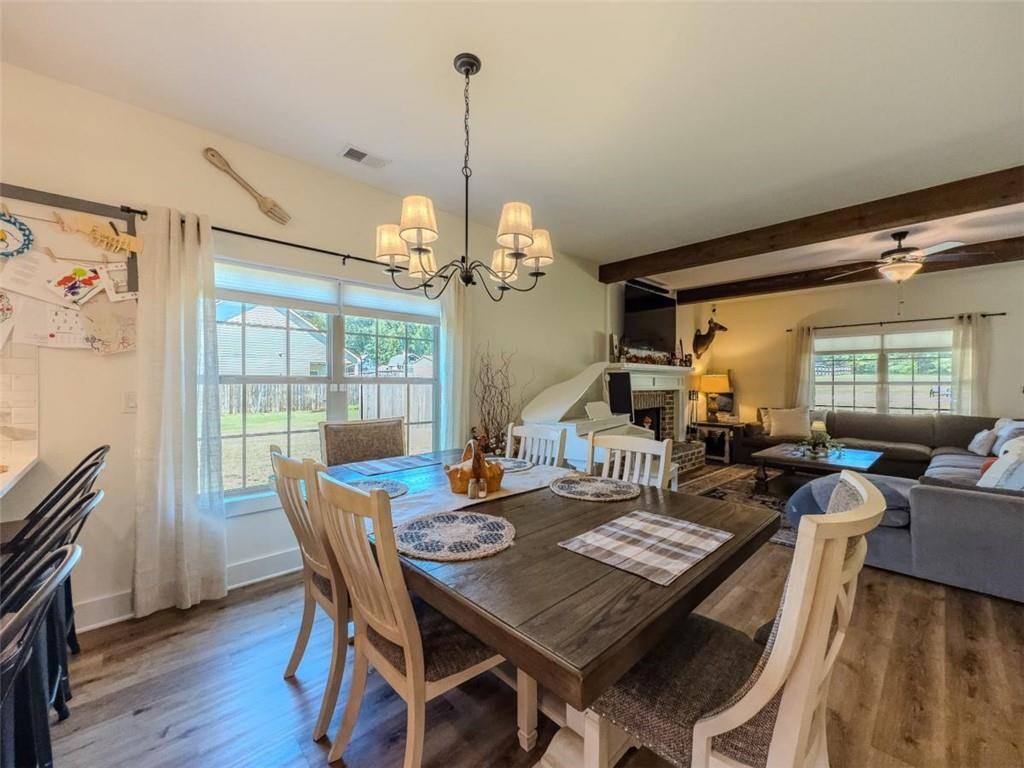 710 Poplar Street Monroe, GA 30655 - Photo 17 of 60 a view of a dining room with furniture wooden floor and chandelier
