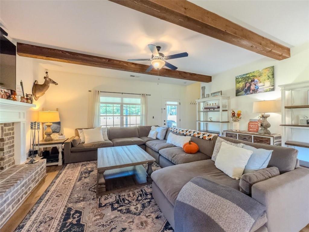 710 Poplar Street Monroe, GA 30655 - Photo 20 of 60 a living room with furniture a rug and a chandelier