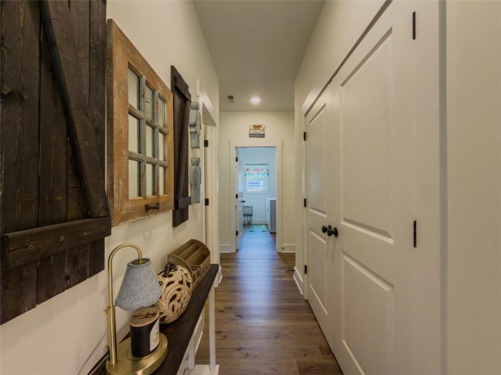 710 Poplar Street Monroe, GA 30655 - Photo 23 of 60 a hallway with furniture a wooden floor and next to a window