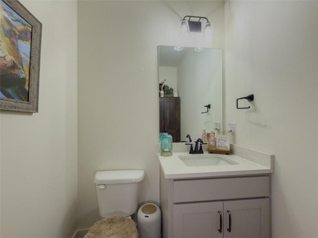 710 Poplar Street Monroe, GA 30655 - Photo 24 of 60 a bathroom with a toilet sink and mirror