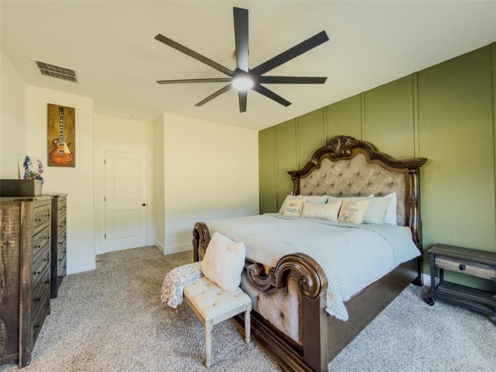 710 Poplar Street Monroe, GA 30655 - Photo 27 of 60 a bedroom with a bed and a chandelier