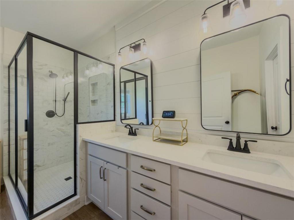 710 Poplar Street Monroe, GA 30655 - Photo 30 of 60 a bathroom with double vanity sinks double vanity and a shower