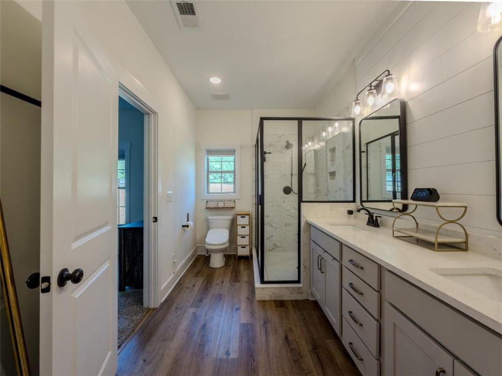 710 Poplar Street Monroe, GA 30655 - Photo 32 of 60 a spacious bathroom with a double vanity sink a mirror and a shower