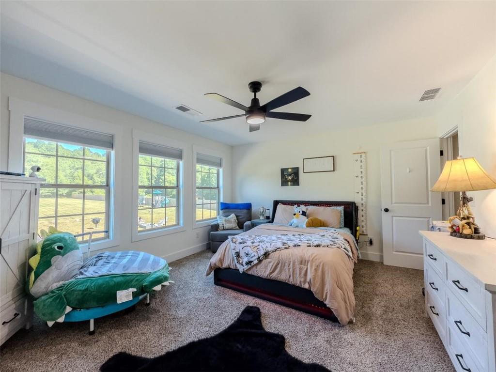 710 Poplar Street Monroe, GA 30655 - Photo 36 of 60 a bedroom with a bed dresser and a window