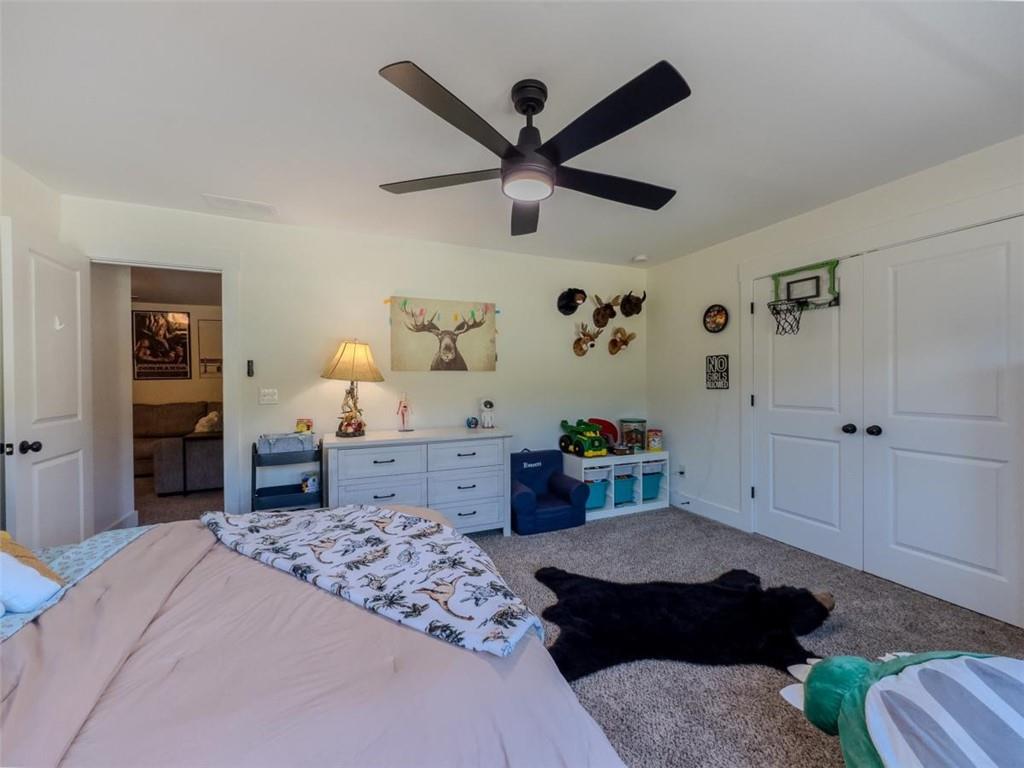 710 Poplar Street Monroe, GA 30655 - Photo 38 of 60 a bedroom with a bed and a chandelier