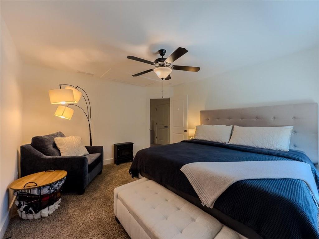 710 Poplar Street Monroe, GA 30655 - Photo 46 of 60 a bedroom with a bed and a chandelier