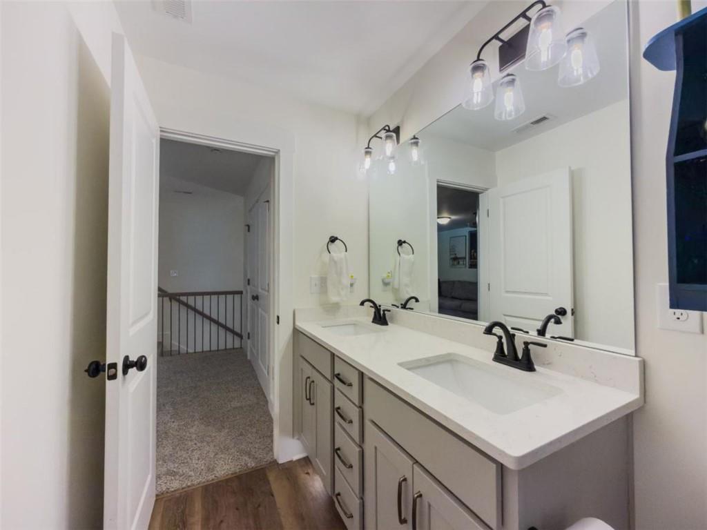 710 Poplar Street Monroe, GA 30655 - Photo 48 of 60 a bathroom with a sink vanity granite and a mirror
