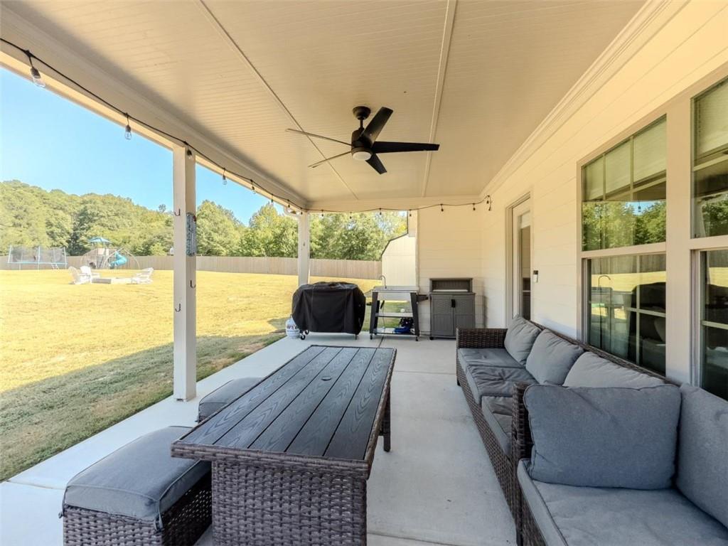 710 Poplar Street Monroe, GA 30655 - Photo 49 of 60 a living room with fireplace furniture and a floor to ceiling window