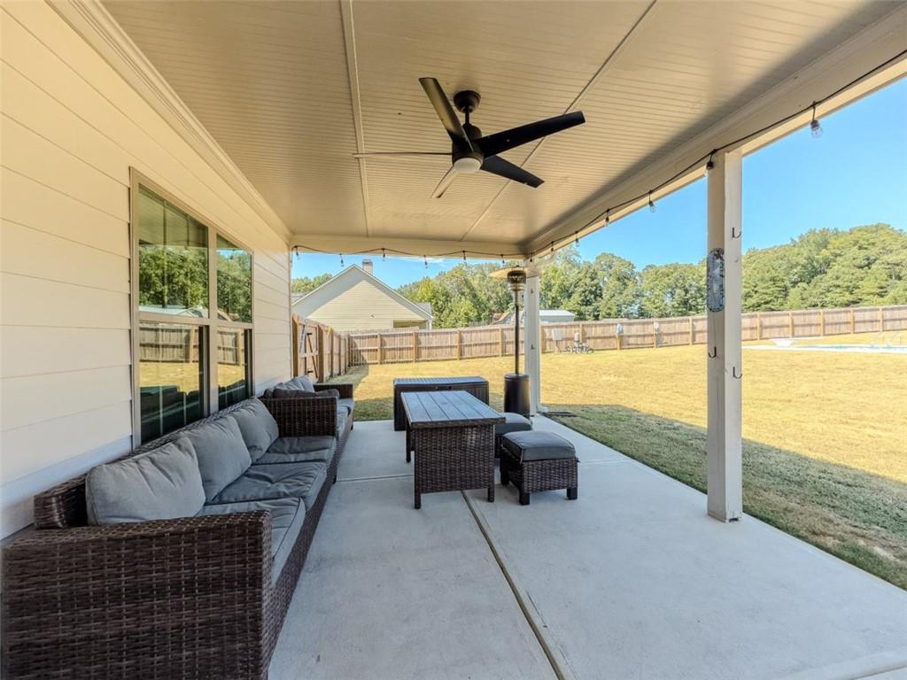 710 Poplar Street Monroe, GA 30655 - Photo 50 of 60 a living room with furniture and a floor to ceiling window